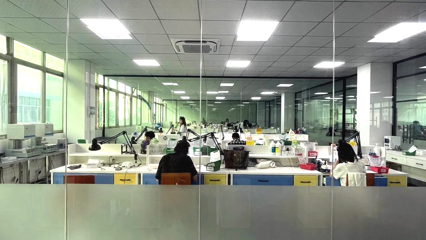 KC Dental Lab workroom — technicians at their benches in the production floor